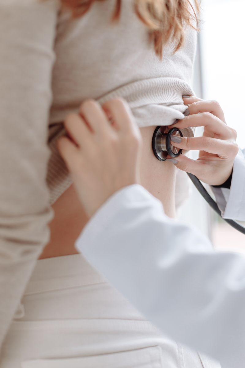 A healthcare professional examining a patient with a stethoscope