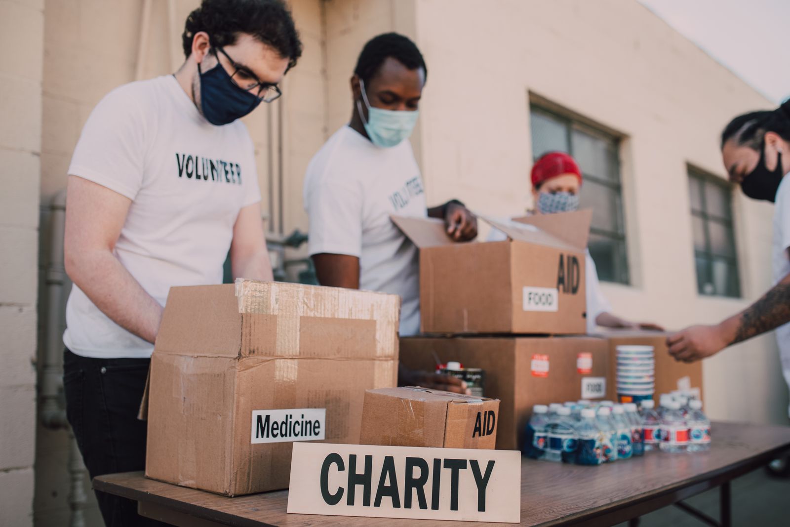 Volunteers preparing boxes of food and medicine for relief distribution